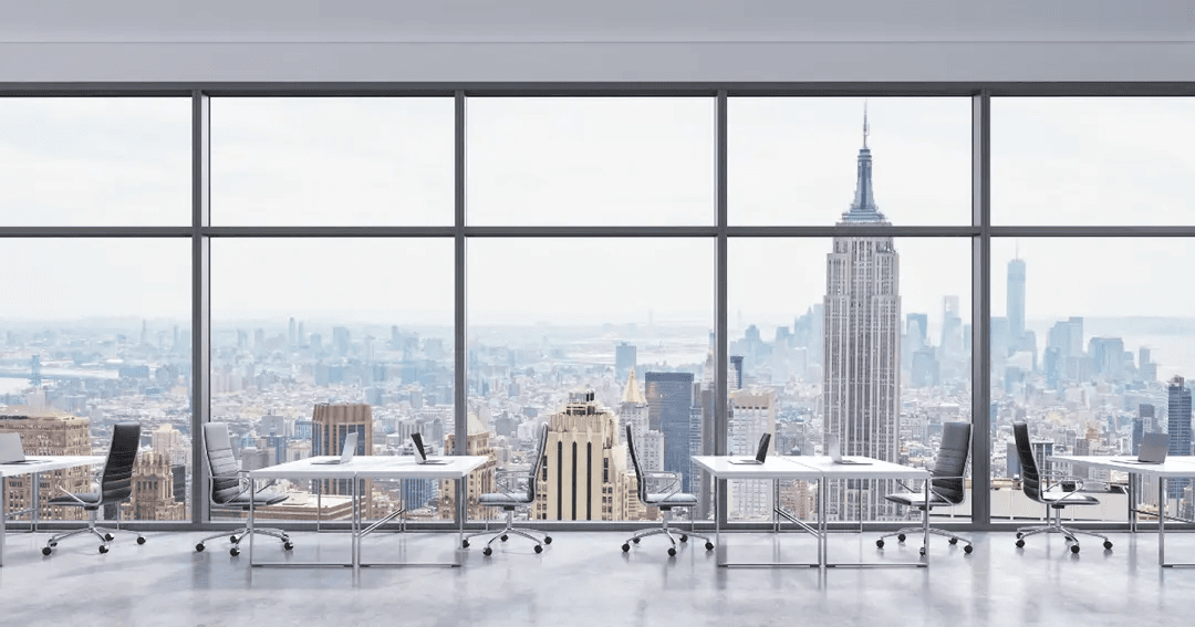An office space with a window view of the New York City skyline.